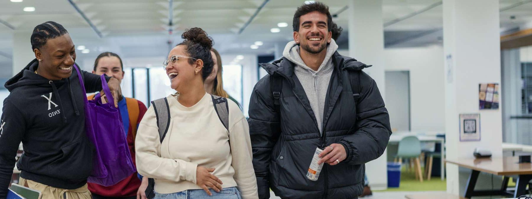 group of students laughing in the Heckman Center